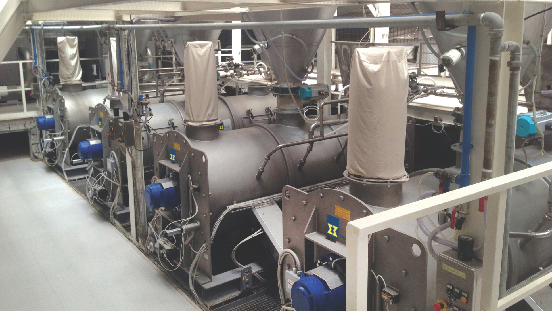 MAP industrial Mixers, mixing machines, continuous and batch mixers Various MAP industrial mixers, placed in a facility room.